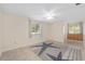 Bright bedroom features tile floors, windows with blinds, and a charming starfish-patterned area rug at 8851 Sw 116Th Street Rd, Ocala, FL 34481
