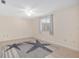 Bright bedroom features tile floors, large window, and a charming starfish-patterned area rug at 8851 Sw 116Th Street Rd, Ocala, FL 34481