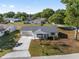 Exterior shot of a one-story home with a lush front yard, garage, and well-maintained landscaping at 8851 Sw 116Th Street Rd, Ocala, FL 34481