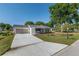 Inviting home with a well-manicured lawn, screened two-car garage, and front porch at 8851 Sw 116Th Street Rd, Ocala, FL 34481