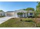 Charming single-story home with a well-manicured lawn and screened two-car garage at 8851 Sw 116Th Street Rd, Ocala, FL 34481