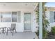 Welcoming front porch with comfortable seating and flowering vines, creating a cozy outdoor space at 8851 Sw 116Th Street Rd, Ocala, FL 34481