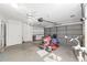 Spacious garage features a lawnmower, bicycle, and overhead storage, offering ample space at 8851 Sw 116Th Street Rd, Ocala, FL 34481