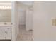 Bright hallway leads to the bathroom and bedroom featuring tile floors at 8851 Sw 116Th Street Rd, Ocala, FL 34481