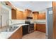 Well-lit kitchen with stainless steel appliances, wood cabinets, and granite countertops, perfect for cooking and entertaining at 8851 Sw 116Th Street Rd, Ocala, FL 34481