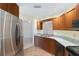 Well-lit kitchen with stainless steel appliances, granite countertops, and wood cabinets at 8851 Sw 116Th Street Rd, Ocala, FL 34481