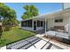 The covered back porch and screened-in lanai overlook the well-maintained fenced backyard at 8851 Sw 116Th Street Rd, Ocala, FL 34481