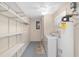 Functional laundry room with shelving, washer, dryer, and a water heater for convenience at 8851 Sw 116Th Street Rd, Ocala, FL 34481