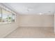 Open living area with tile flooring, large windows, and a ceiling fan, creating a bright and airy space at 8851 Sw 116Th Street Rd, Ocala, FL 34481