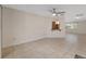 Spacious living room features tile flooring, a ceiling fan, and a pass-through to the kitchen at 8851 Sw 116Th Street Rd, Ocala, FL 34481