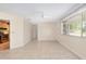 Cozy living room with tile flooring, ceiling fan, and view into the kitchen at 8851 Sw 116Th Street Rd, Ocala, FL 34481