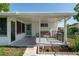 Covered patio features a bench, a small table, and a view of the fenced backyard at 8851 Sw 116Th Street Rd, Ocala, FL 34481