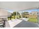 A partially shaded patio features views of the fenced yard at 8851 Sw 116Th Street Rd, Ocala, FL 34481