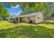 Spacious backyard featuring a screened-in patio, lawn, and mature trees offering shade at 8851 Sw 97Th St # A, Ocala, FL 34481