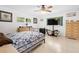 Bright bedroom with a ceiling fan, tile floors, large windows, and a comfortable-looking quilt on the bed at 8851 Sw 97Th St # A, Ocala, FL 34481