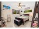 Inviting bedroom featuring a ceiling fan, bright windows with green views, and stylish beach-themed decor at 8851 Sw 97Th St # A, Ocala, FL 34481