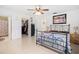 Bedroom boasts a comfortable bed, tile flooring, walk-in closet, and neutral walls at 8851 Sw 97Th St # A, Ocala, FL 34481