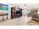 Open-concept living room featuring tile floors, a large entertainment center, and comfortable seating at 8851 Sw 97Th St # A, Ocala, FL 34481