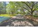 Street view of a lushly landscaped neighborhood with mature trees and well-maintained lawns at 8851 Sw 97Th St # A, Ocala, FL 34481