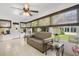 Sunroom with tile flooring, a neutral sofa, and large windows offering views of the backyard at 8851 Sw 97Th St # A, Ocala, FL 34481