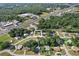 An aerial view of a home in a wooded neighborhood near a highway and commercial area at 8954 Sw 104Th Ln, Ocala, FL 34481