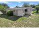 The home features a partial lattice-covered patio area and a compact yard, offering a cozy outdoor space at 8954 Sw 104Th Ln, Ocala, FL 34481
