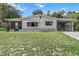 Charming single-story home with covered carport and well-maintained lawn, nestled among mature trees at 8954 Sw 104Th Ln, Ocala, FL 34481