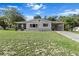 Exterior view of house featuring a carport, well-kept lawn, and neutral-toned siding at 8954 Sw 104Th Ln, Ocala, FL 34481