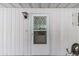 A close-up shot of the white front door featuring a screen and diamond pattern design at 8954 Sw 104Th Ln, Ocala, FL 34481