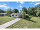 Charming single-story home with a long driveway and well-maintained lawn on a beautiful sunny day at 8954 Sw 104Th Ln, Ocala, FL 34481