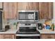 Close-up of the stainless steel oven and microwave with wood cabinets in the kitchen at 8954 Sw 104Th Ln, Ocala, FL 34481