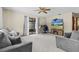 Comfortable living room with plush gray furniture, large TV, and sliding glass doors at 8954 Sw 104Th Ln, Ocala, FL 34481