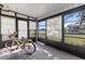 Bright sunroom featuring a charming bicycle with a basket and a window view of the yard at 8954 Sw 104Th Ln, Ocala, FL 34481