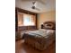 Comfortable bedroom featuring a built-in headboard and storage, complemented by a ceiling fan at 9121 Sw 83Rd Ct # C, Ocala, FL 34481