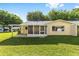 Large green backyard featuring a cozy screened-in porch, ideal for enjoying the outdoors at 9320 Sw 89Th Ter # C, Ocala, FL 34481
