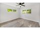Bright bedroom with wood-look flooring and two windows that provide ample natural light at 9320 Sw 89Th Ter # C, Ocala, FL 34481