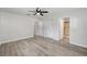 Bedroom featuring wood-look flooring, closet, and doorway to an ensuite bathroom at 9320 Sw 89Th Ter # C, Ocala, FL 34481