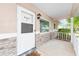 View of the home's covered front porch with brick accents, painted front door and address clearly displayed at 9320 Sw 89Th Ter # C, Ocala, FL 34481