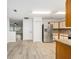 Bright kitchen featuring stainless steel appliances, ample cabinet space, and laminate flooring at 9320 Sw 89Th Ter # C, Ocala, FL 34481
