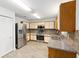 Spacious kitchen with stainless steel refrigerator, double sink, laminate flooring, and neutral countertops at 9320 Sw 89Th Ter # C, Ocala, FL 34481