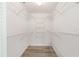Walk-in closet with wood-look flooring and metal shelving on all walls at 9320 Sw 89Th Ter # C, Ocala, FL 34481