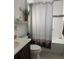 Cozy bathroom with tub and shower combination, a patterned shower curtain, and a small sink at 9764 Sw 100Th Avenue Rd, Ocala, FL 34481
