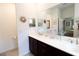 Bathroom with double vanity, white countertops, and decorative mirrors at 9764 Sw 100Th Avenue Rd, Ocala, FL 34481