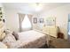 Bright bedroom featuring neutral walls, ceiling fan, and floral bedding at 9764 Sw 100Th Avenue Rd, Ocala, FL 34481