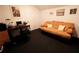 Versatile bonus room with a futon, desk, and dark flooring for a cozy retreat at 9764 Sw 100Th Avenue Rd, Ocala, FL 34481