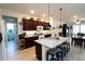 Open kitchen with granite countertops, a breakfast bar with seating, and modern appliances at 9764 Sw 100Th Avenue Rd, Ocala, FL 34481