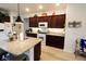 Kitchen with granite countertops, white appliances, ample cabinet space, and modern lighting at 9764 Sw 100Th Avenue Rd, Ocala, FL 34481