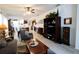 Inviting living room with comfortable seating, a stylish rug, and a wooden entertainment center at 9764 Sw 100Th Avenue Rd, Ocala, FL 34481