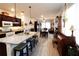 Open-concept living space with a kitchen island, dining area, and cozy living room furniture at 9764 Sw 100Th Avenue Rd, Ocala, FL 34481