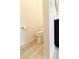 Toilet room with wood look flooring, toilet and roll of toilet paper at 9764 Sw 100Th Avenue Rd, Ocala, FL 34481